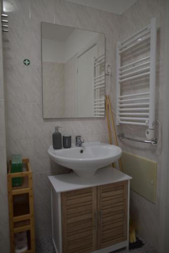 a bathroom with a white sink and a mirror at Rita's house in Ponta Delgada