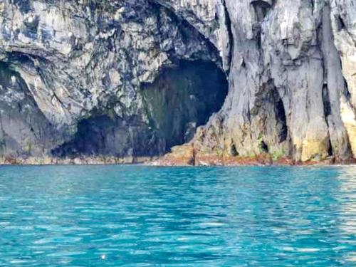 a view of a cave from the water at 8 person holiday home in Bølandet-By Traum in Røyra