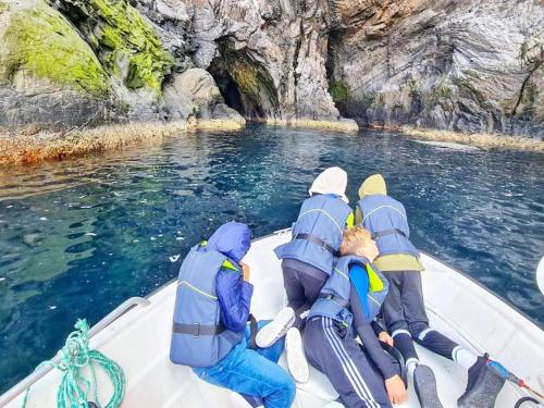 a group of people on a boat in the water at 8 person holiday home in Bølandet-By Traum in Røyra