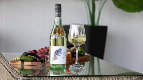 a bottle of wine and a glass on a table at River Shack in Shoalhaven Heads
