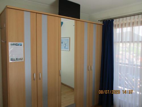 a large wooden wardrobe with a television on top at Gästehaus zur schönen Aussicht in Spitz