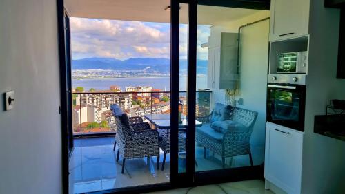 a kitchen with a balcony with a table and chairs at Amazing Sea & Mountain Duplex in Izmit in Izmit