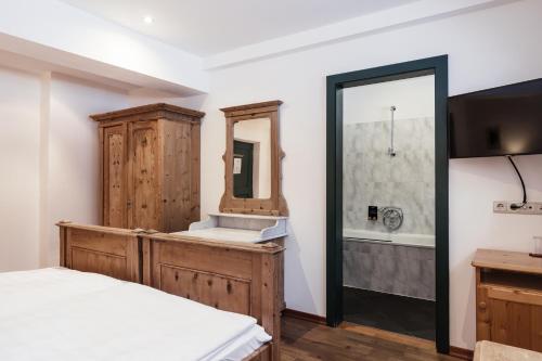 a bathroom with a sink and a mirror at Hotel Dolomitenhof & Chalet Alte Post in Sesto