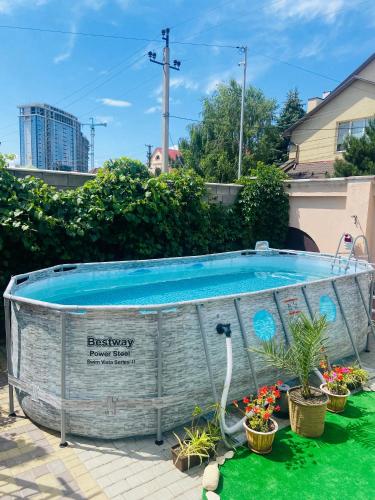 a swimming pool in a yard with potted plants at Готель Лаванда на Ривьере , Карпатский чан, Фонтанка 1 Одесса in Fontanka