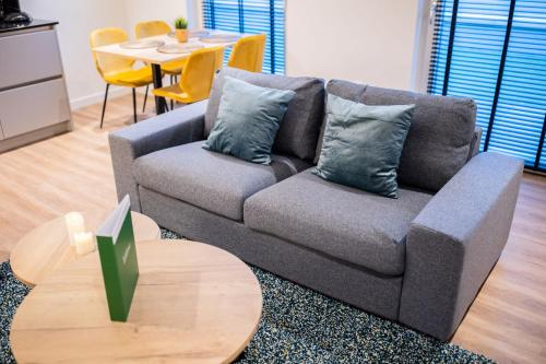 a living room with a couch and a table at Friendly 50m2 One-Bedroom Apartment - WE39A in Tiel