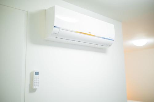 a white refrigerator with a light on the ceiling at Friendly 50m2 One-Bedroom Apartment - WE39A in Tiel