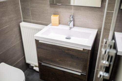 a bathroom with a white sink and a toilet at Friendly 50m2 One-Bedroom Apartment - WE39A in Tiel