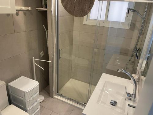 a bathroom with a shower and a toilet and a sink at El Luquillo on the beach in Mogán