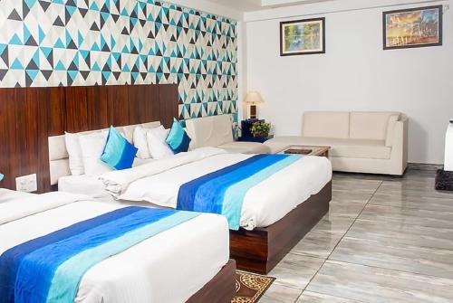 Postel nebo postele na pokoji v ubytování Hotel SGT Plaza