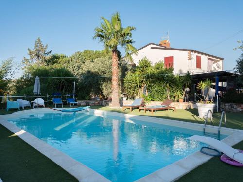 a swimming pool in front of a house at La casa di Gioggiò in Ioppolo Giancaxio