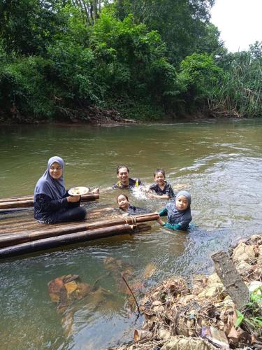 a group of people in the water on a raft at Rasa Durio Eco Glampz in Rasa