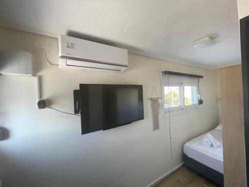a room with a flat screen tv on the wall at ParkSide Loft in Kalamata