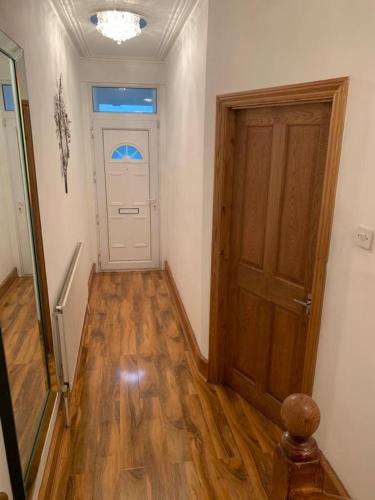 a hallway with a door and a wooden floor at FBS Homestay in Norwood