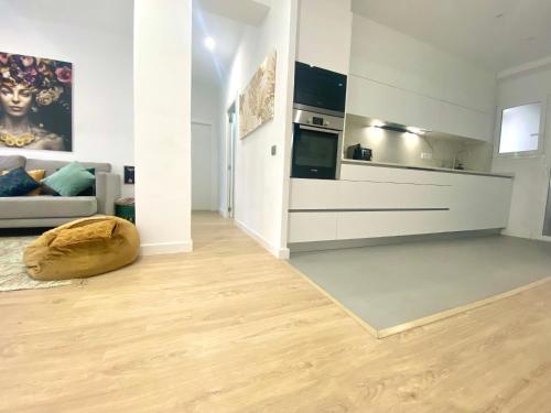 a living room with a couch and a kitchen at Barcelona Chic Apartments- Free Parking-10 min by metro from BCN Center in Barcelona