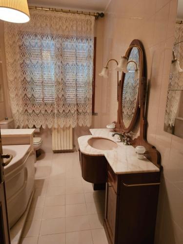 a bathroom with a sink and a mirror at Padre Relais di Campagna in Collemezzano