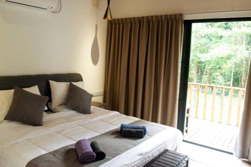 1 dormitorio con 1 cama grande y 2 almohadas en Zen Forest Entire Villa with Private Pool at Karak, en Kampung Sunjai Gapoi