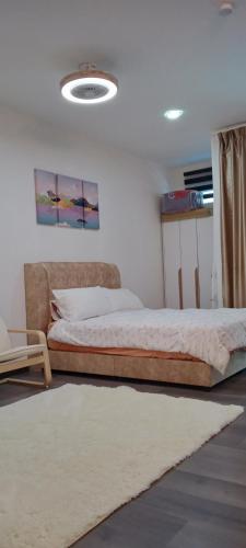a bedroom with two beds and a rug at Melangok Homestay in Kajang