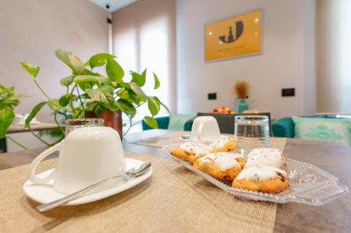 a table with a plate of donuts on a table at Welcome Cagliari in Cagliari