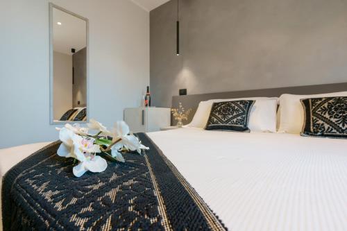 a bedroom with a large bed with flowers on it at Welcome Cagliari in Cagliari