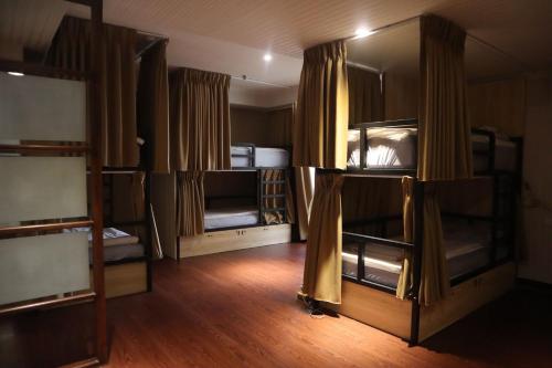 a room with several bunk beds in it at Hermes Hotel in Hsinchu City