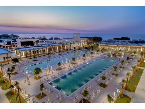 an overhead view of a resort pool with chairs and tables at Swandor Hotels & Resorts - Kemer in Kemer