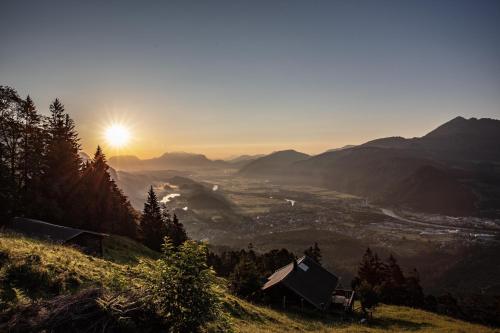 a view of a valley with the sun setting on a mountain at Chalet Innertal in Inneralpbach