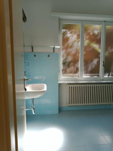 a bathroom with a sink and a window at Cube 1B Flat in Lugano