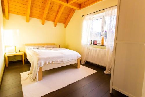 a bedroom with a bed in a room with a window at Schwarzwaldtraum am Weinberg in Sasbachwalden