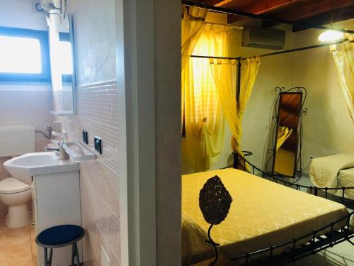 a bathroom with a yellow bed and a sink at West Coast in Càbras