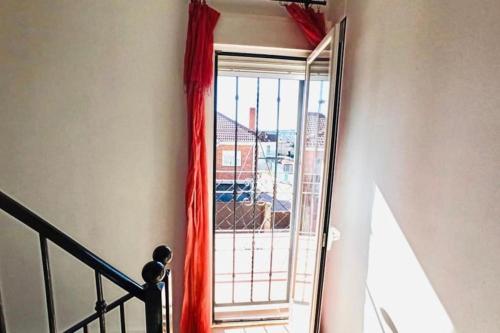 a door with a red curtain and a window at Casa del Río in Móstoles