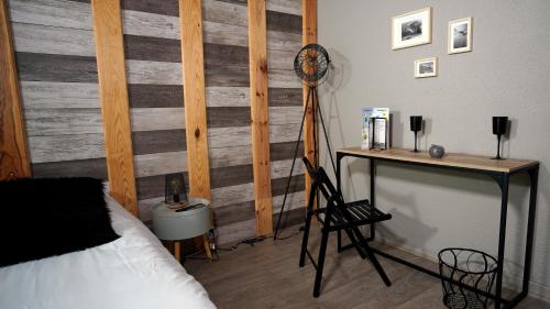 a bedroom with a bed and a desk with a tripod at La Sapinière St Lary Soulan in Saint-Lary-Soulan
