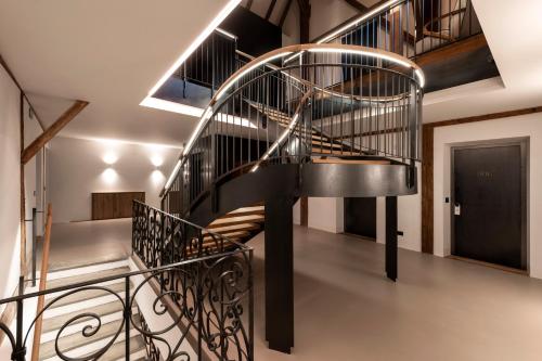 a metal spiral staircase in a room with a hallway at Castel Hörtenberg in Bolzano