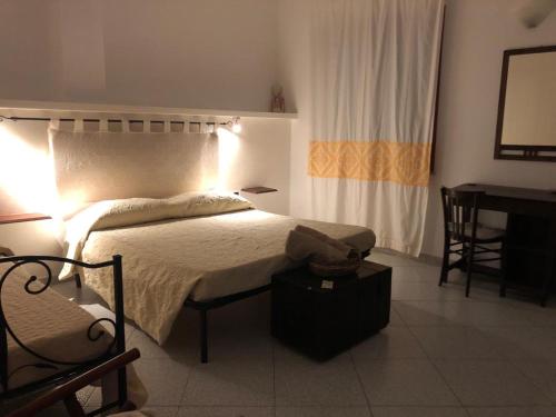a bedroom with a bed and a table and a desk at West Coast in Càbras