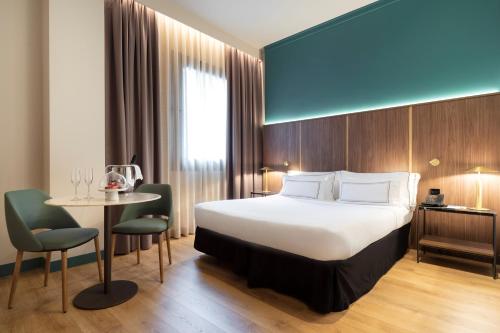 a hotel room with a bed and a table at Meliá Milano in Milan