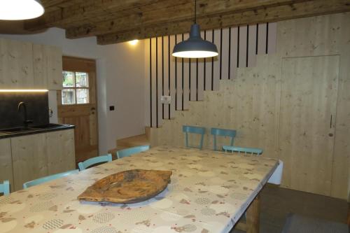 a dining room with a table with a wooden bowl on it at Baita Misonet in Comano Terme