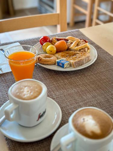 a table with a plate of food and two cups of coffee at Agriturismo Masseria Cannella in Lesina