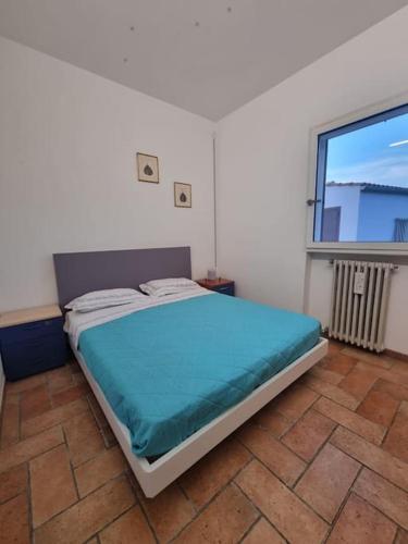 a bed in a room with a large window at CasaMè - Villa Castelli in Villa Castelli
