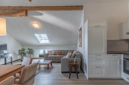 a kitchen and living room with a couch and a table at Haus Seidendorf in Sankt Kanzian