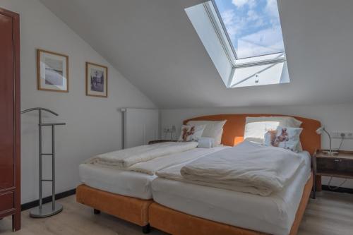 a bedroom with a large bed and a window at Haus Seidendorf in Sankt Kanzian