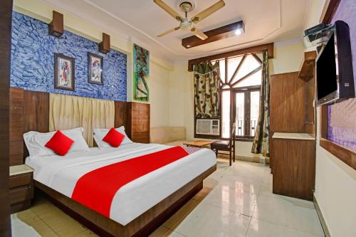 a bedroom with a large bed and a tv at Flagship S S G Residency in Mysore