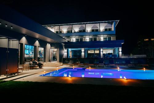 a house with a swimming pool at night at Aqua Blu Hotel in Bad Füssing