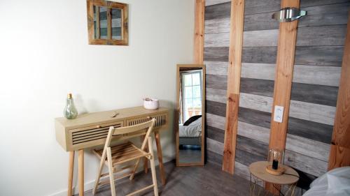 a room with a desk and a mirror at La Sapinière St Lary Soulan in Saint-Lary-Soulan