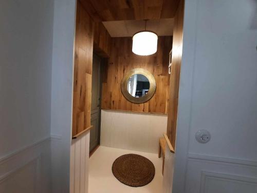 a hallway with a round mirror and a room with a rug at Põlva Maja apartments - contactless check-in in Põlva