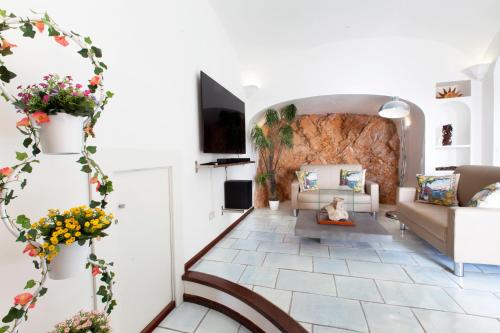 a living room with a couch and a table at Faraglionensis MonaconeHouse Villa in Capri