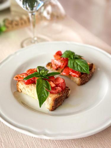 a white plate with two pieces of toast with strawberries at Agriturismo Masseria Cannella in Lesina