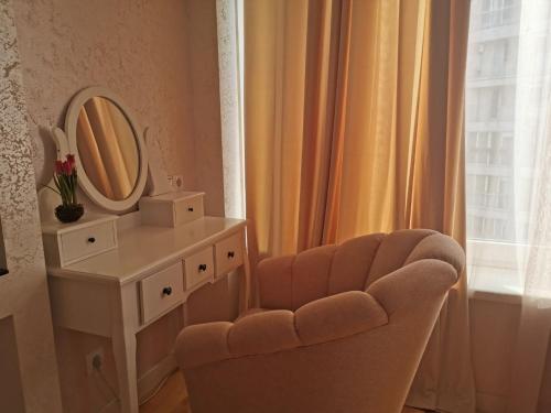 a dressing room with a chair and a mirror at Stunning new design apartment next to park in Chişinău