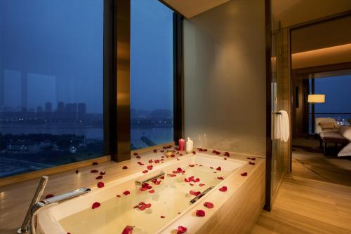 a bathroom with a bath tub with roses in it at Crowne Plaza Fuzhou Riverside, an IHG Hotel in Fuzhou