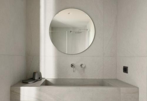 a bathroom with a sink and a mirror at Kale Alti residences in Mirina