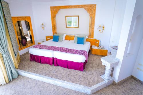 a bedroom with a large bed in a room at Hasdrubal Thalassa & Spa Yasmine Hammamet in Hammamet