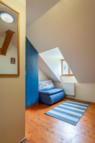 a living room with a blue couch and a blue rug at Penzión Príjemný Oddych in Banská Štiavnica